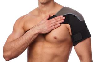Man with a support bandage on his shoulder photo