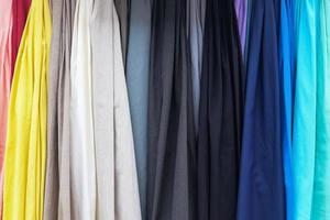 Detailed close up view on samples of cloth and fabrics in different colors found at a fabrics market photo