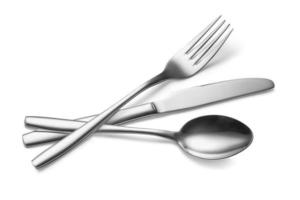 The metal shiny spoon, fork and knife on a white photo