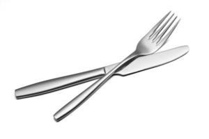 The metal shiny fork and knife on a white background. photo