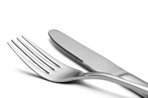 The metal shiny fork and knife on a white background. photo