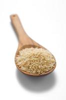 Brown rice in the wood spoon photo