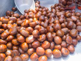 Pile of chestnuts roasted for sale in a market photo