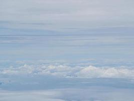 Aerial view of cloudscape seen through airplane window photo