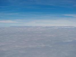 Aerial view of cloudscape seen through airplane window photo