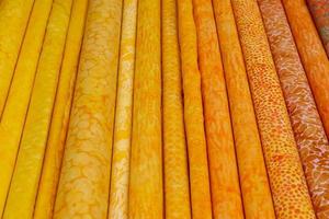 Detailed close up view on samples of cloth and fabrics in different colors found at a fabrics market photo