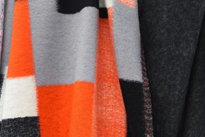 Detailed close up view on samples of cloth and fabrics in different colors found at a fabrics market photo