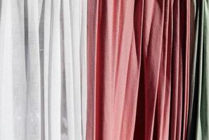Detailed close up view on samples of cloth and fabrics in different colors found at a fabrics market photo