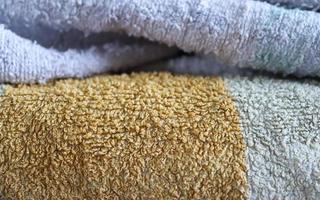 Detailed close up view on samples of cloth and fabrics in different colors found at a fabrics market photo