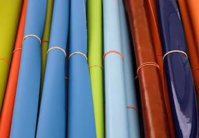 Detailed close up view on samples of cloth and fabrics in different colors found at a fabrics market photo