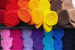 Detailed close up view on samples of cloth and fabrics in different colors found at a fabrics market photo