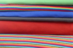 Detailed close up view on samples of cloth and fabrics in different colors found at a fabrics market photo