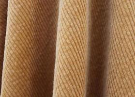 Detailed close up view on samples of cloth and fabrics in different colors found at a fabrics market photo