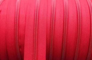 Detailed close up view on samples of zippers in different colors found at a fabrics market photo