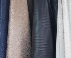 Detailed close up view on samples of cloth and fabrics in different colors found at a fabrics market photo