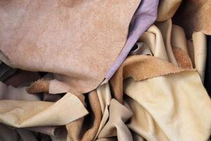 Detailed close up view on samples of cloth and fabrics in different colors found at a fabrics market photo