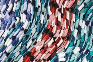 Detailed close up view on samples of cloth and fabrics in different colors found at a fabrics market photo
