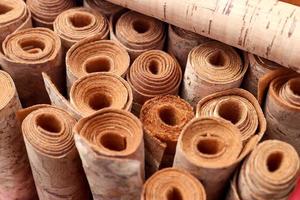 Close up view on rolled samples of cloth and fabrics in different colors found at a fabrics market.. photo