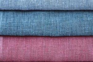 Detailed close up view on samples of cloth and fabrics in different colors found at a fabrics market photo