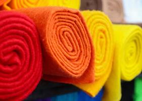 Detailed close up view on samples of cloth and fabrics in different colors found at a fabrics market photo