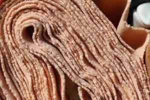Detailed close up view on samples of cloth and fabrics in different colors found at a fabrics market photo