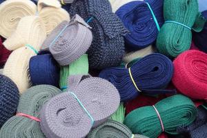Detailed close up view on samples of zippers in different colors found at a fabrics market photo