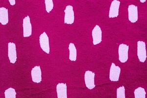 Detailed close up view on samples of cloth and fabrics in different colors found at a fabrics market photo