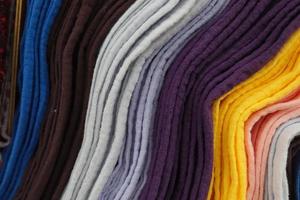 Close up view on samples of cloth and fabrics in different colors found at a fabrics market photo