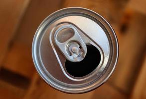 Close up top view up a can of soft drink isolated on wooden background photo