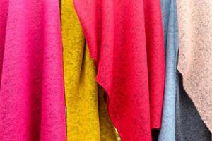 Close up view on samples of cloth and fabrics in different colors found at a fabrics market photo