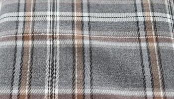 Detailed close up view on samples of cloth and fabrics in different colors found at a fabrics market photo