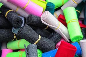 Detailed close up view on samples of cloth and fabrics in different colors found at a fabrics market photo