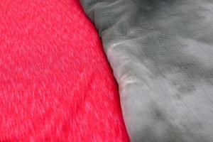 Detailed close up view on samples of cloth and fabrics in different colors found at a fabrics market photo