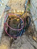 View into a small excavation pit with cables lying around. photo