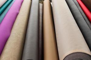 Detailed close up view on samples of cloth and fabrics in different colors found at a fabrics market photo