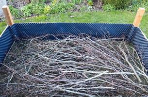 Raised herbal bed during construction with some branches in it photo