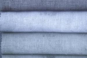Detailed close up view on samples of cloth and fabrics in different colors found at a fabrics market photo