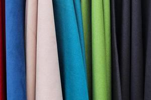 Detailed close up view on samples of cloth and fabrics in different colors found at a fabrics market photo