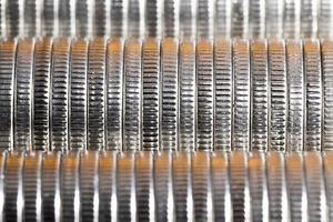 many round metal coins of silver color illuminated in red photo