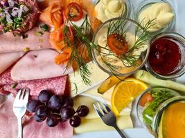 Close view on a healthy german breakfast with cheese, tomatoes and butter. photo