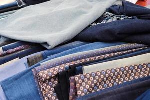 Detailed close up view on samples of cloth and fabrics in different colors found at a fabrics market photo