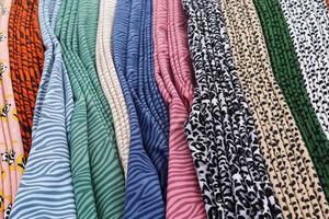Detailed close up view on samples of cloth and fabrics in different colors found at a fabrics market photo