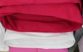 Detailed close up view on samples of cloth and fabrics in different colors found at a fabrics market photo