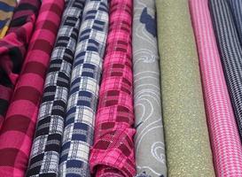Detailed close up view on samples of cloth and fabrics in different colors found at a fabrics market photo