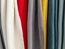 Detailed close up view on samples of cloth and fabrics in different colors found at a fabrics market photo