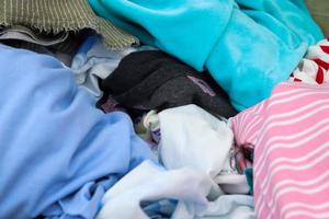 Detailed close up view on samples of cloth and fabrics in different colors found at a fabrics market photo