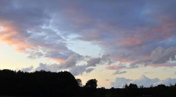 Beautiful panorama of orange and yellow clouds at sunrise photo