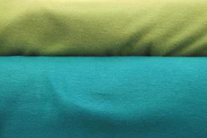 Detailed close up view on samples of cloth and fabrics in different colors found at a fabrics market photo