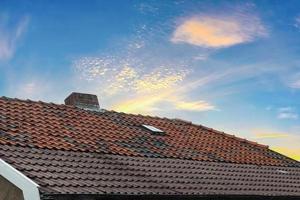 Roof window in velux style with dark roof tiles. photo