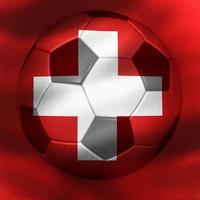 3D-Illustration of a Swiss flag with a soccer ball moving in the wind photo